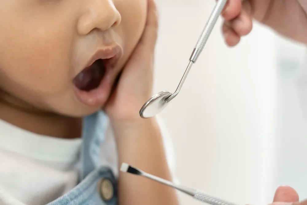 A dentist examining a child’s teeth