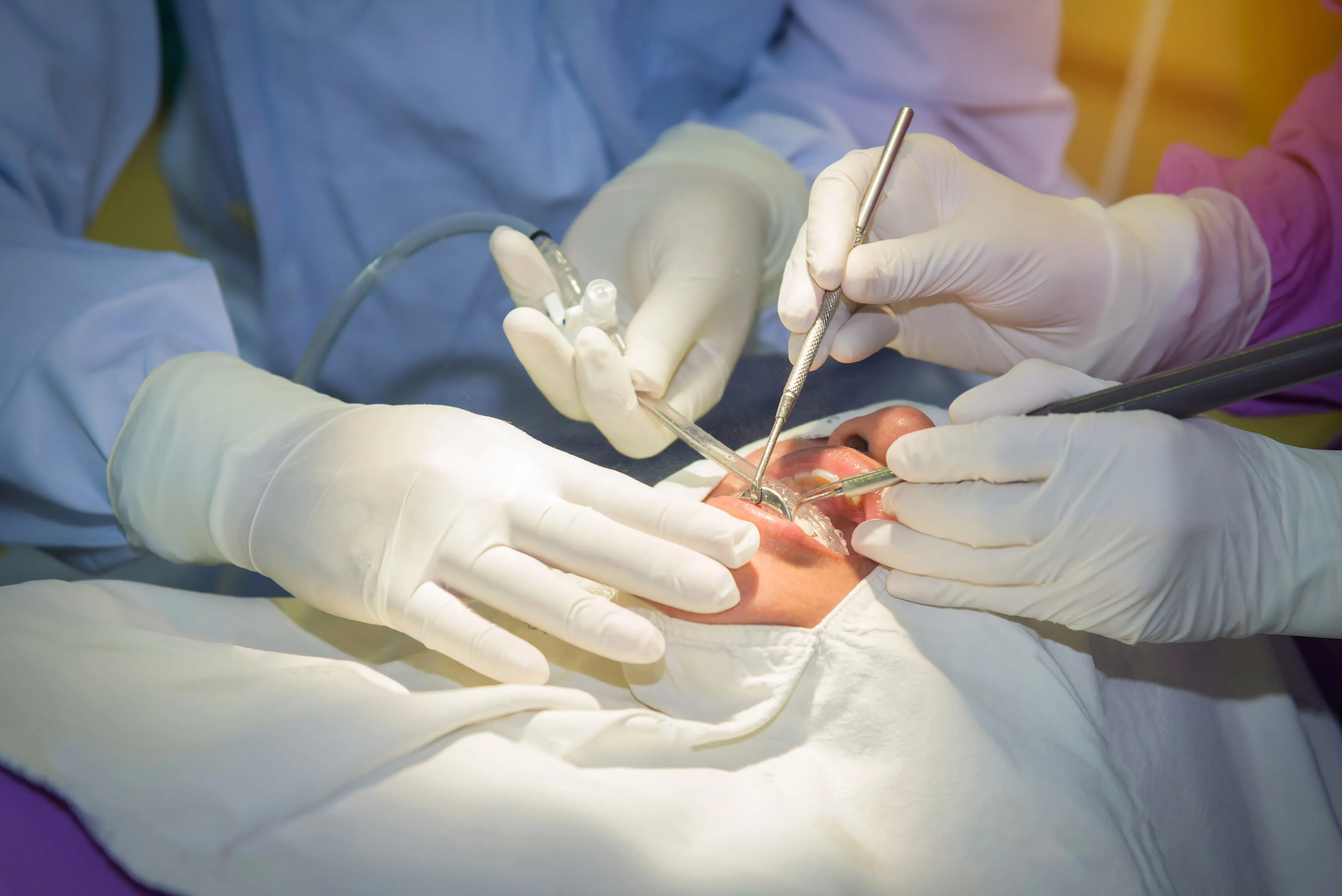 A dental team performing a procedure on a patient
